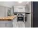 Bright kitchen showcasing butcher block countertops, stainless steel appliances, and white shaker-style cabinetry at 1500 Cenith Dr. # B-403, North Myrtle Beach, SC 29582