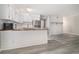 Open kitchen area with white cabinets, butcher block countertops, stainless steel appliances, and modern gray flooring at 1500 Cenith Dr. # B-403, North Myrtle Beach, SC 29582