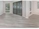 Bright living room with light-grey wood-look flooring and sliding doors for access to the outdoors at 1500 Cenith Dr. # B-403, North Myrtle Beach, SC 29582