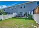 A backyard with a patio set, well-maintained lawn, and a white picket fence at 153 Goldenrod Circle # 7D, Little River, SC 29566