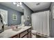 Bathroom with a vanity, framed art, and a shower with a white curtain at 153 Goldenrod Circle # 7D, Little River, SC 29566