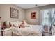 Comfortable bedroom with white bedding, bedside table and decorative artwork at 153 Goldenrod Circle # 7D, Little River, SC 29566