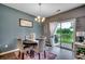Cozy dining area with a chandelier, sliding glass doors leading to the backyard at 153 Goldenrod Circle # 7D, Little River, SC 29566