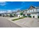 View of the townhome complex with neatly kept lawns and driveways on a sunny day at 153 Goldenrod Circle # 7D, Little River, SC 29566