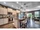 Open kitchen with granite counters, stainless appliances, and barstool seating at kitchen island at 153 Goldenrod Circle # 7D, Little River, SC 29566