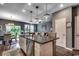 Open kitchen with granite island and stainless dishwasher has views to dining and living area at 153 Goldenrod Circle # 7D, Little River, SC 29566