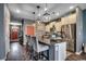 Open concept kitchen featuring stainless refrigerator, granite countertops, and an island with bar stool seating at 153 Goldenrod Circle # 7D, Little River, SC 29566