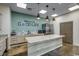 The kitchen features an island with granite countertops, a stainless steel refrigerator, and stylish pendant lighting at 153 Goldenrod Circle # 7D, Little River, SC 29566