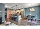 Open-concept living space with kitchen island, dining area, and modern lighting fixtures at 153 Goldenrod Circle # 7D, Little River, SC 29566