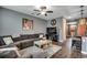 Comfortable living room featuring a large sectional sofa, ceiling fan, and stylish decor at 153 Goldenrod Circle # 7D, Little River, SC 29566
