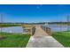 A scenic pond offers a wooden walkway for enjoying the outdoor space at 153 Goldenrod Circle # 7D, Little River, SC 29566