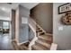 Carpeted staircase with white railings and wood accents, leading to the upper level at 153 Goldenrod Circle # 7D, Little River, SC 29566