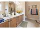 Bathroom with a double vanity, a large mirror and a decorative painting at 165 Northside Dr., Little River, SC 29566