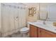 Clean bathroom featuring a single vanity sink and a shower with floral curtain at 165 Northside Dr., Little River, SC 29566