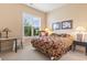 Cozy bedroom featuring a large window letting in natural light and floral bedding at 165 Northside Dr., Little River, SC 29566