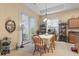 Cozy dining area with natural light, wood table and chairs, and neutral color scheme at 165 Northside Dr., Little River, SC 29566