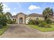 Charming single-story home with a brick driveway and lush landscaping at 165 Northside Dr., Little River, SC 29566