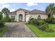 Well-kept home featuring lush landscaping, a brick paver driveway, and a charming facade at 165 Northside Dr., Little River, SC 29566