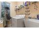 Functional laundry room with washer, dryer, utility sink, and storage shelves at 165 Northside Dr., Little River, SC 29566