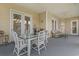 Inviting covered patio with glass topped dining table and seating with great views at 165 Northside Dr., Little River, SC 29566