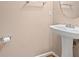This bathroom has a pedestal sink with wood floors at 1654 Low Country Pl. # C, Myrtle Beach, SC 29577