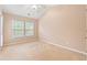 A bright bedroom has a neutral carpet and natural light streaming in from two windows at 1654 Low Country Pl. # C, Myrtle Beach, SC 29577