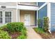 Close-up of entrance showcasing neat landscaping leading to white front door at 1654 Low Country Pl. # C, Myrtle Beach, SC 29577