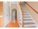 Inviting entryway with wood floors, white trim, and staircase to upper level at 1654 Low Country Pl. # C, Myrtle Beach, SC 29577