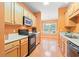 Galley kitchen with wood cabinets, white countertops, and black appliances at 1654 Low Country Pl. # C, Myrtle Beach, SC 29577