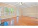 Sunlit living room with wood floors, large windows, and neutral color palette at 1654 Low Country Pl. # C, Myrtle Beach, SC 29577