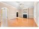 Open-concept living room with wood floors, fireplace, and archway to the kitchen at 1654 Low Country Pl. # C, Myrtle Beach, SC 29577