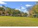 Scenic pond with lush green lawn, bordered by an elegant black fence and decorative landscaping at 1654 Low Country Pl. # C, Myrtle Beach, SC 29577