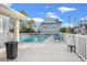 A community pool is flanked by lounge chairs, trees, and community buildings at 1654 Low Country Pl. # C, Myrtle Beach, SC 29577