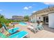 Beautiful backyard with a pool, lounge chairs, and covered patio with seating at 1715 Lake Egret Dr., North Myrtle Beach, SC 29582