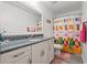 Bathroom with a patterned shower curtain, granite countertop, and white cabinetry at 1715 Lake Egret Dr., North Myrtle Beach, SC 29582
