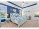 Beautiful bedroom with blue accent wall, tray ceiling, comfortable bed, and lots of natural light at 1715 Lake Egret Dr., North Myrtle Beach, SC 29582