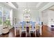 Charming dining room featuring hardwood floors, a tray ceiling, and a beautifully set table for entertaining at 1715 Lake Egret Dr., North Myrtle Beach, SC 29582