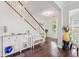 Inviting foyer featuring hardwood floors, a staircase with wrought iron spindles, and stylish decor at 1715 Lake Egret Dr., North Myrtle Beach, SC 29582