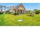 Beautifully landscaped front yard with a charming home featuring a covered front porch at 1715 Lake Egret Dr., North Myrtle Beach, SC 29582