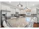 Bright kitchen with granite countertops, a large island with seating, and stainless steel appliances at 1715 Lake Egret Dr., North Myrtle Beach, SC 29582
