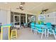Covered patio with teal dining set, ceiling fans, and a bar area at 1715 Lake Egret Dr., North Myrtle Beach, SC 29582