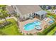 Aerial view showcasing a private backyard oasis with a kidney-shaped pool, spa, and covered patio at 1715 Lake Egret Dr., North Myrtle Beach, SC 29582