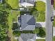 Overhead shot of a home with backyard patio, surrounded by green lawn and mature trees at 185 Rocko Dr., Myrtle Beach, SC 29579