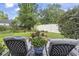 Serene backyard view with patio chairs overlooking a lush green lawn and landscaped garden at 185 Rocko Dr., Myrtle Beach, SC 29579