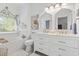 Bright bathroom features double sinks, floral accents, a soaking tub, and a soft, neutral palette at 185 Rocko Dr., Myrtle Beach, SC 29579