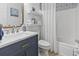 Stylish bathroom with a navy vanity, marble countertop, and a shower/tub combination with white tile at 185 Rocko Dr., Myrtle Beach, SC 29579