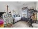 Cozy bedroom with wood floors, easel, bookshelves, and an eclectic decor at 185 Rocko Dr., Myrtle Beach, SC 29579