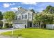 Inviting two-story home with a lush lawn, a two-car garage, and a welcoming front porch at 185 Rocko Dr., Myrtle Beach, SC 29579