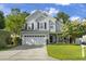 Charming two-story home with a well-manicured lawn, two-car garage, and inviting front porch at 185 Rocko Dr., Myrtle Beach, SC 29579
