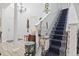 Bright hallway features a stair lift, chandelier, and a beautiful plant stand at 185 Rocko Dr., Myrtle Beach, SC 29579